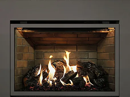 Modern gas fireplace with brick interior and realistic log set.