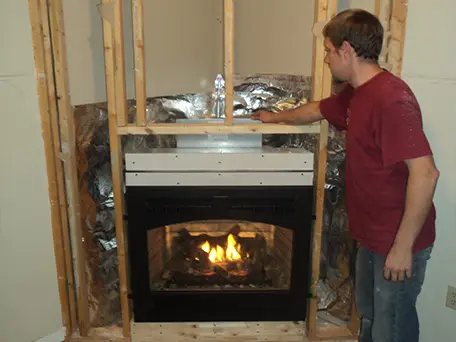 Gas fireplace installation in progress, showing the unit framed in during construction.