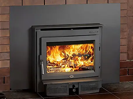Quadra-Fire wood burning stove installed in a brick fireplace
