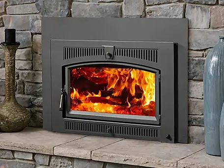 High-efficiency wood-burning fireplace insert with glowing embers.