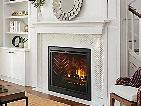 Modern gas fireplace with brick interior and black frame, installed in a white mantel.