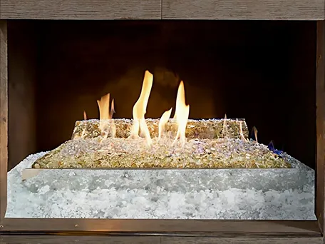 Modern gas fireplace with amber glass fire media and white ice crystals