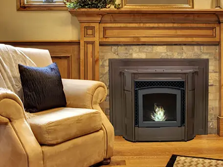 Modern gas fireplace installed in a living room with tan armchair